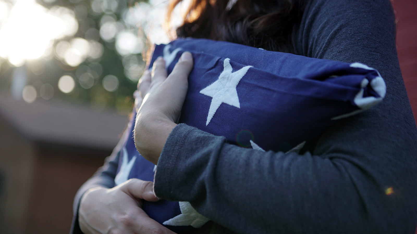 A child holds a folded flag